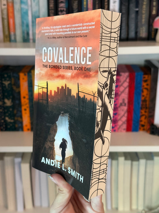 A book titled 'Convalence The Bonded Series, Book One' by Andie L. Smith displayed in front of a bookshelf