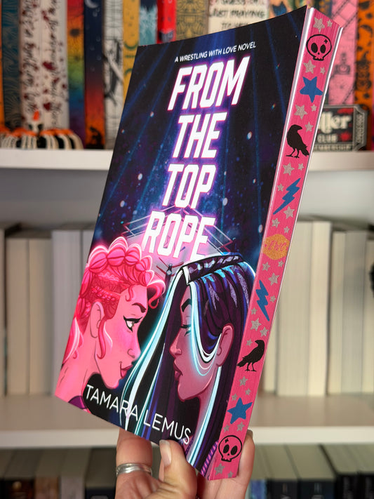 A book titled 'From the Top Rope' by Tamara Lemus displayed in front of a bookshelf